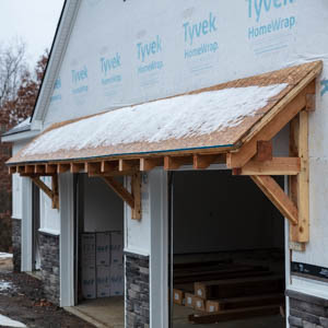 eastern red cedar garage eyebrow roof over two doors