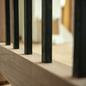 solid black steel spindles going into railing