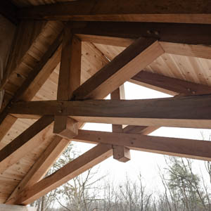 timber framed scissor trusses on front porch roof