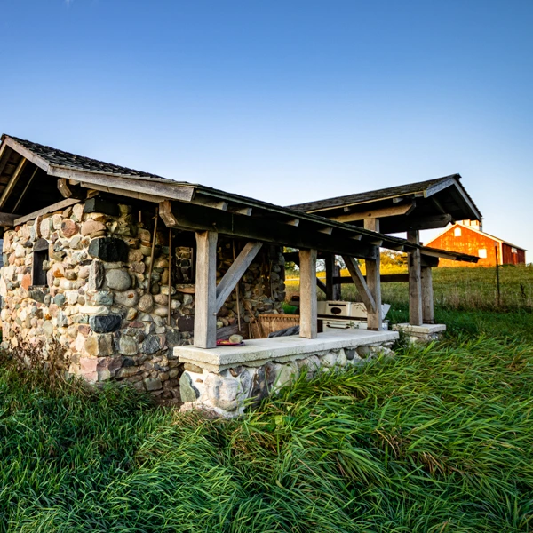 Stone shed with timber framed porch roof