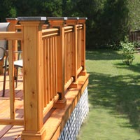 cedar deck railing with granite post cap and metal railing brackets