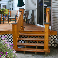 cedar deck stairs with railing and granite post caps