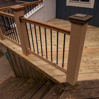 textured deck posts with cedar railing and black spindles